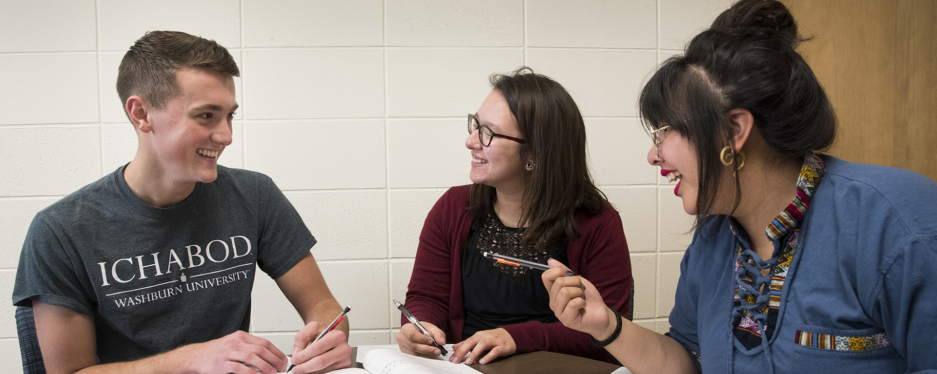 Students talk and laugh while studying