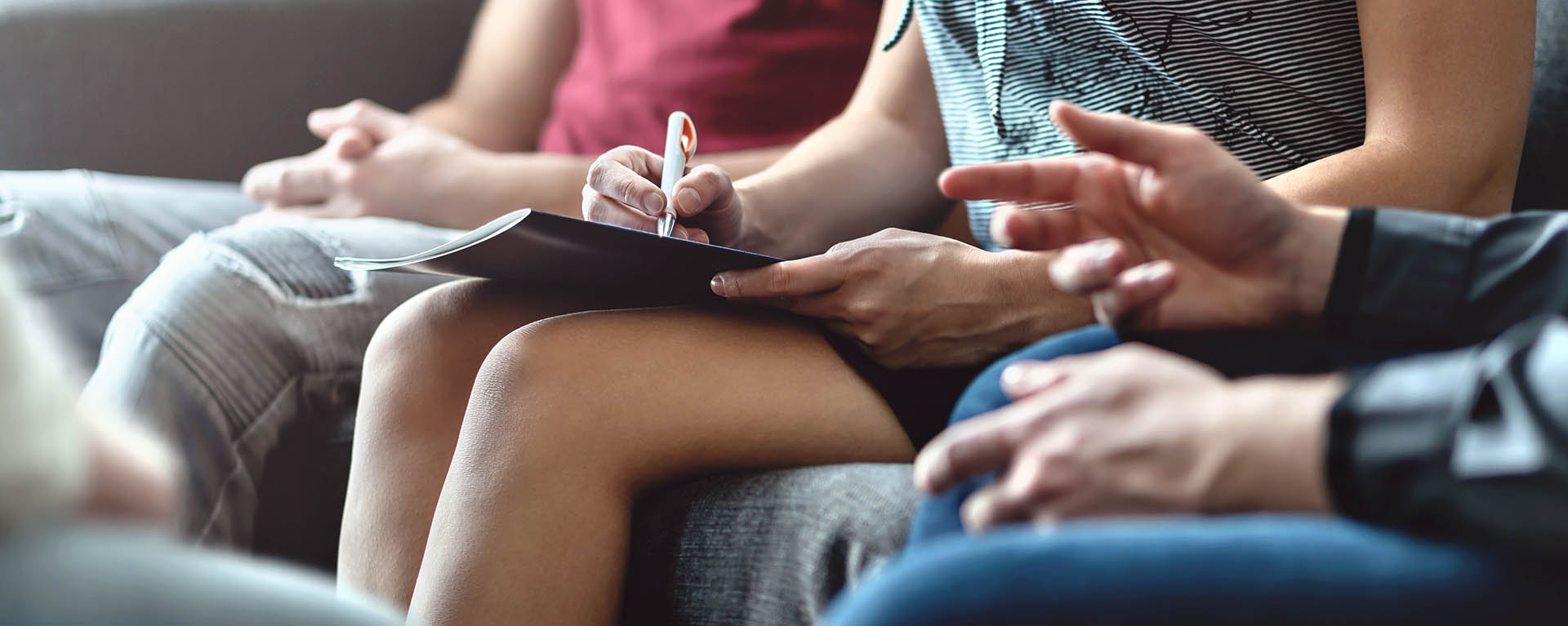 Hands gesture while people talk in a group.