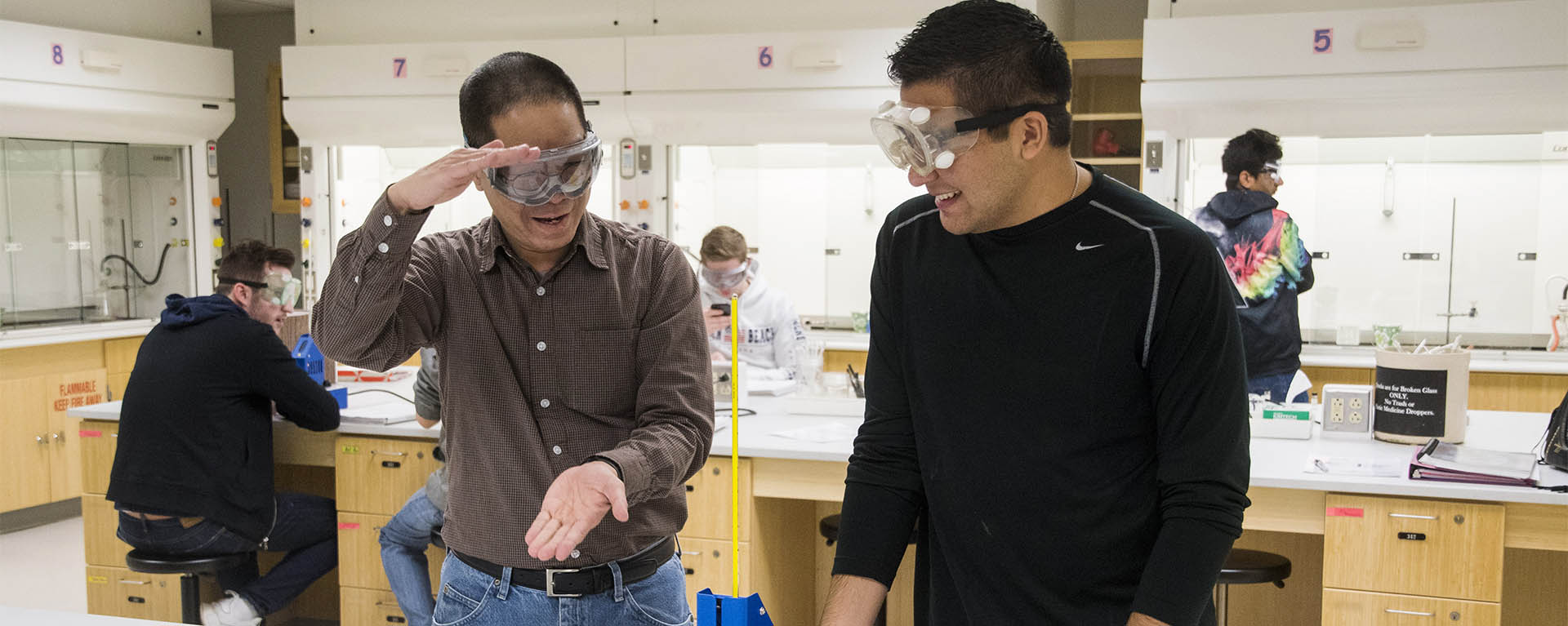 A professor explain something to a student in a lab