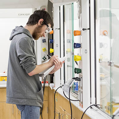 A student takes notes during a lab