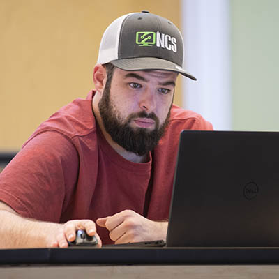 A student works on a laptop in class.