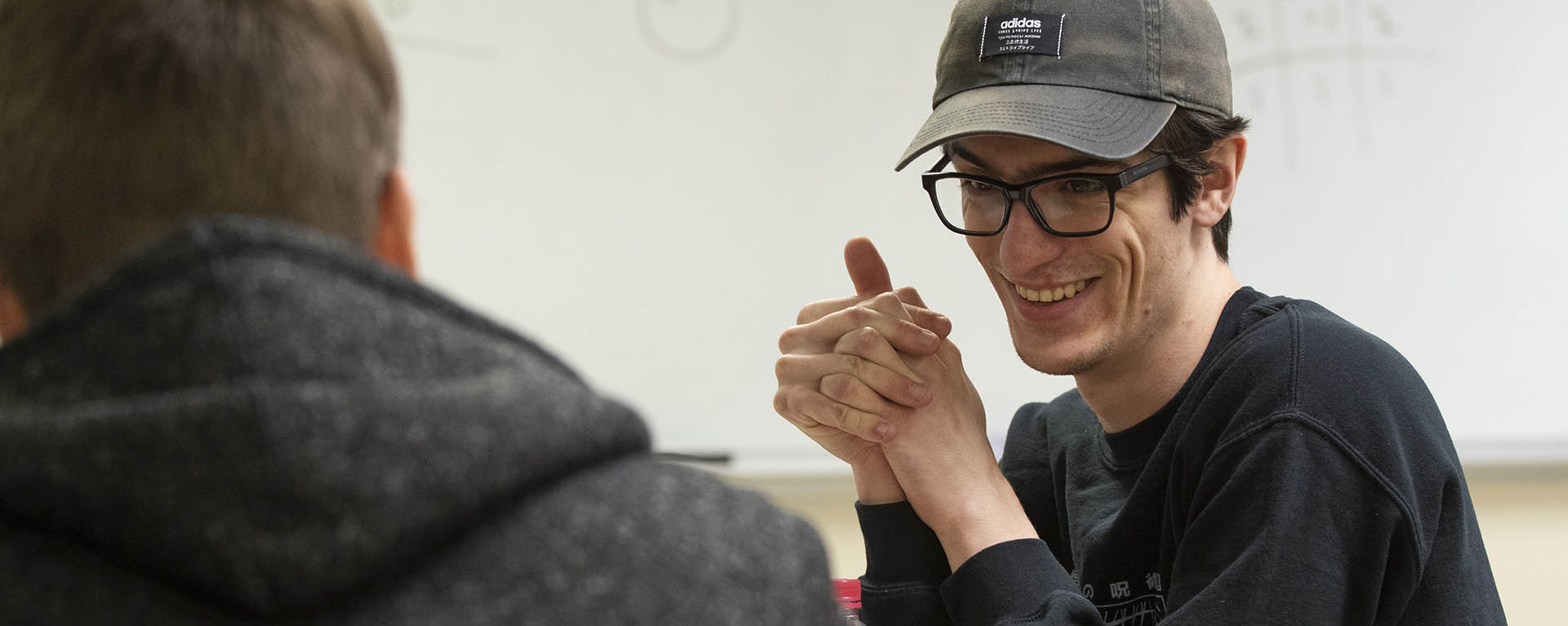 A student laughs while in a computer gaming class.