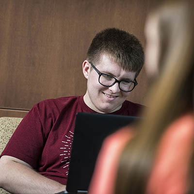 A Washburn student focuses on an assignment during class