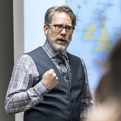 A history professor speaks passionately while teaching.