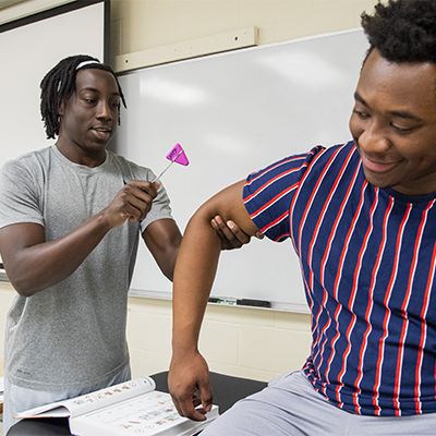 A student observes someone doing a fitness test.