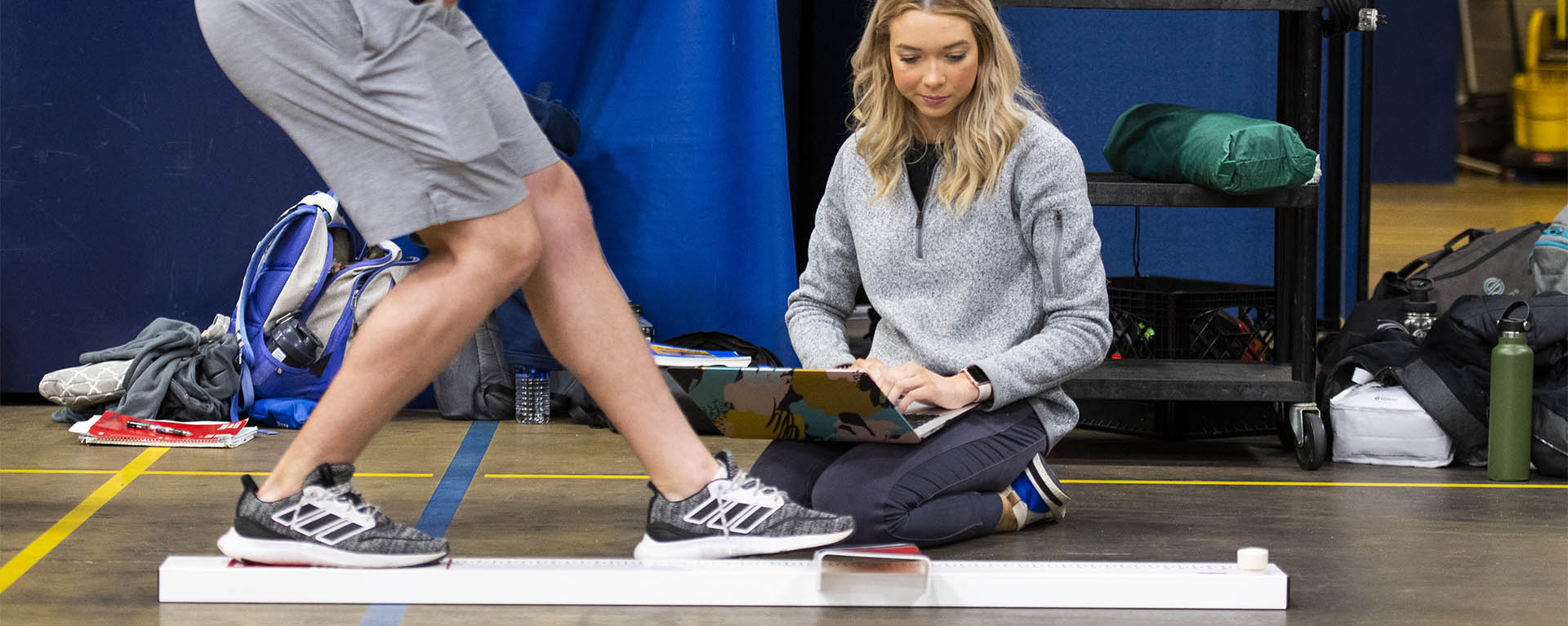 A student observes a fitness test.