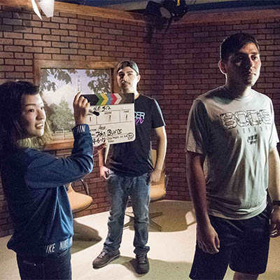 Students prepare to shoot a scene for class.