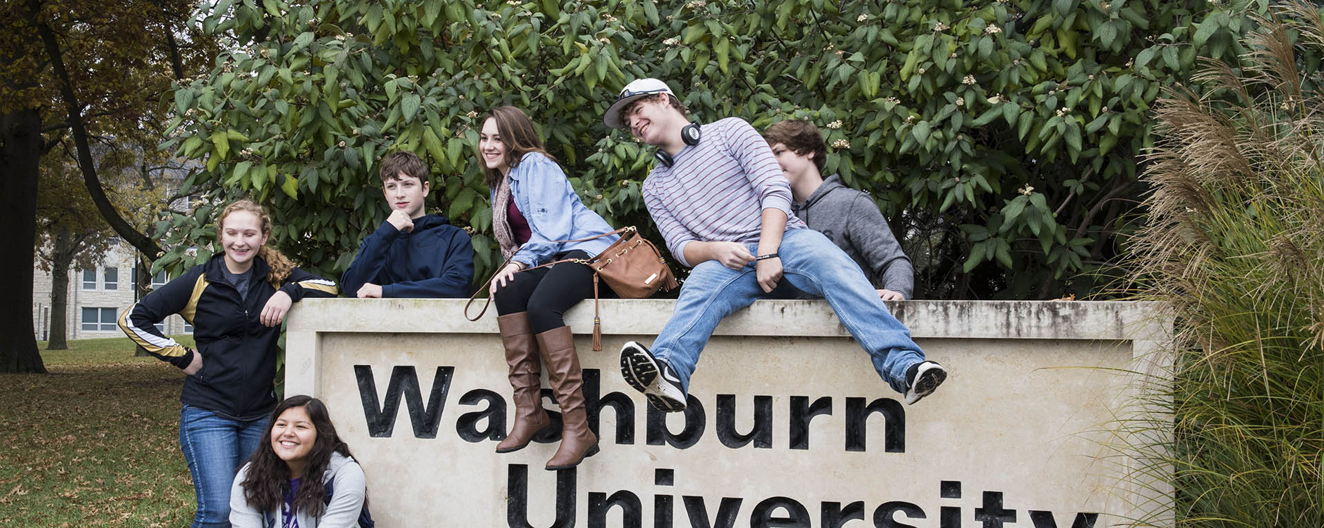 Students pose around a Washburn sign at math day.