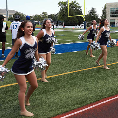 Group of Dancing Blues cheers on football field
