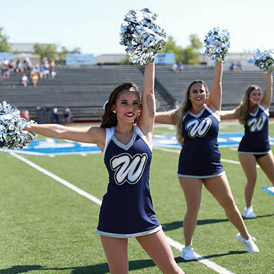 Dancing Blue smiles and cheers on sideline with other Blues