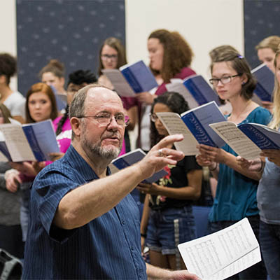 Professor directs the choir during class