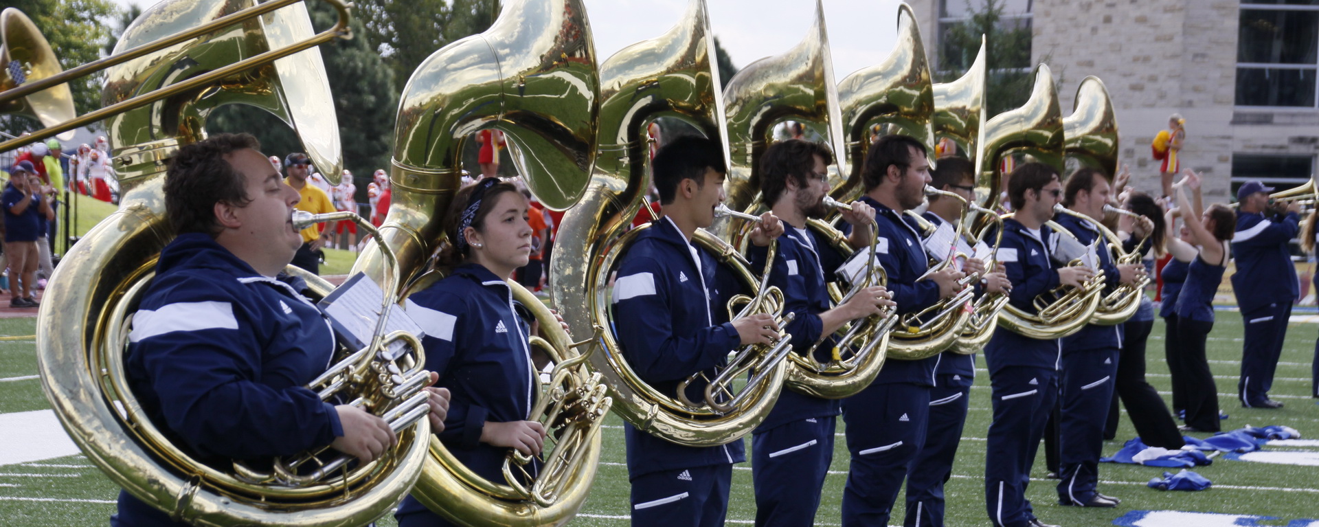Marching Blues tuba players on football field