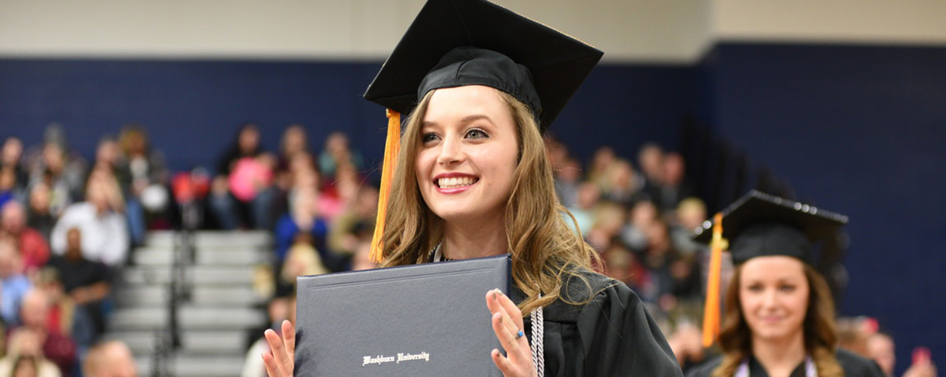 Female graduate standing at commencement