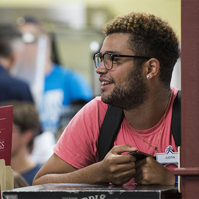 A student smiles while in the library.