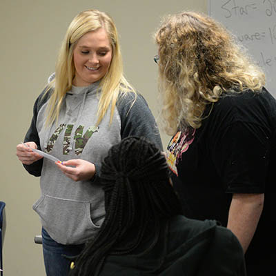 Sociology students discuss a project in class.