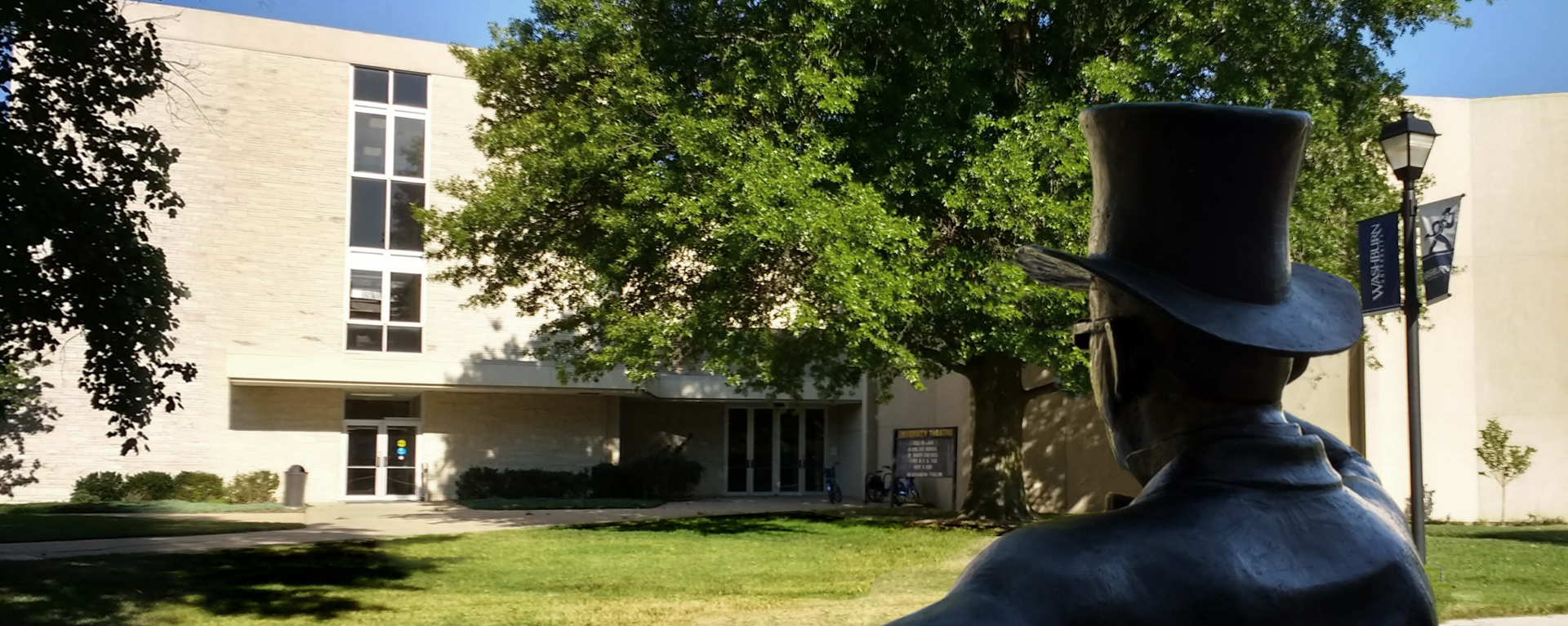 exterior of theatre with ichabod statue in foreground looking toward theatre