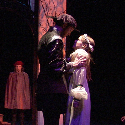Theatre production photo from Rozencrantz and Gildenstern are Dead showing a man and woman embracing