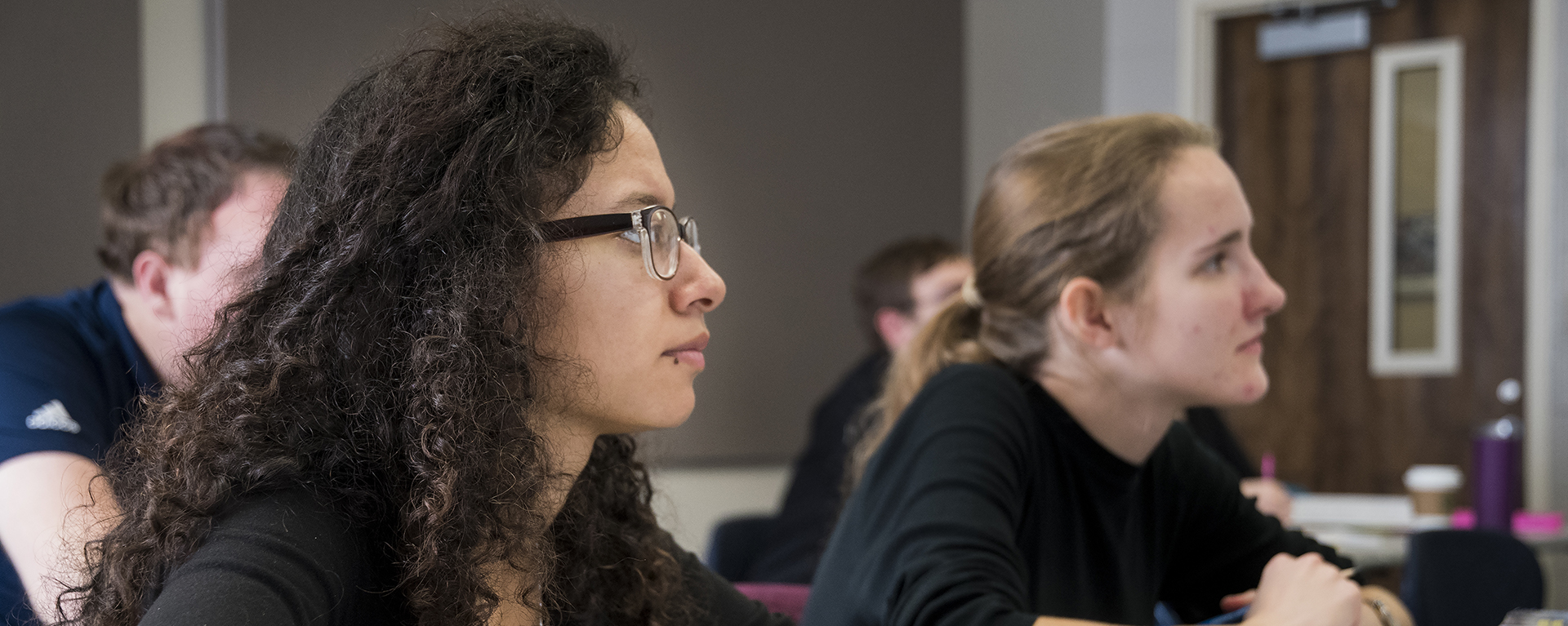 A Washburn student takes notes during a lecture in a Department of Music class.