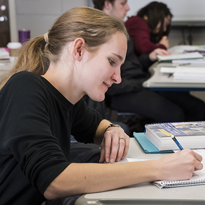 A Department of Music student listens during a class lecture.