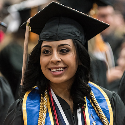 A Washburn student smiles during commencement before she becomes an alumna