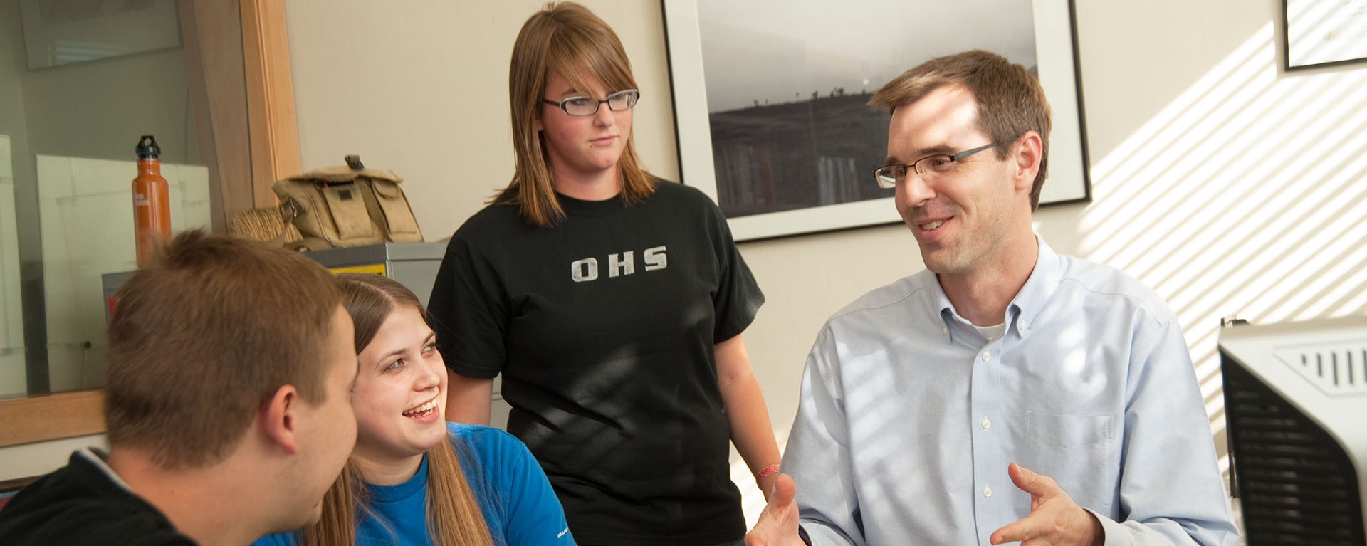 An English professor works with students in Morgan Hall.