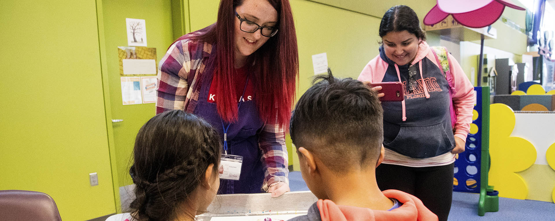 A bonner scholar volunteers in a children's museum as part of their project.