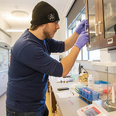 A student holds up a test tube of a sample