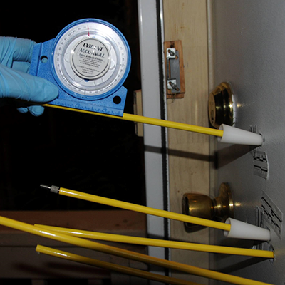 Students exam bullet holes with an instrument