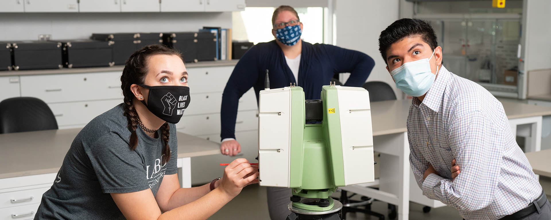 Students using a crime scene scanner in a classroom.