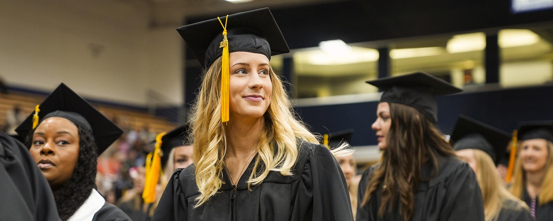 student smiles during commencement ceremony