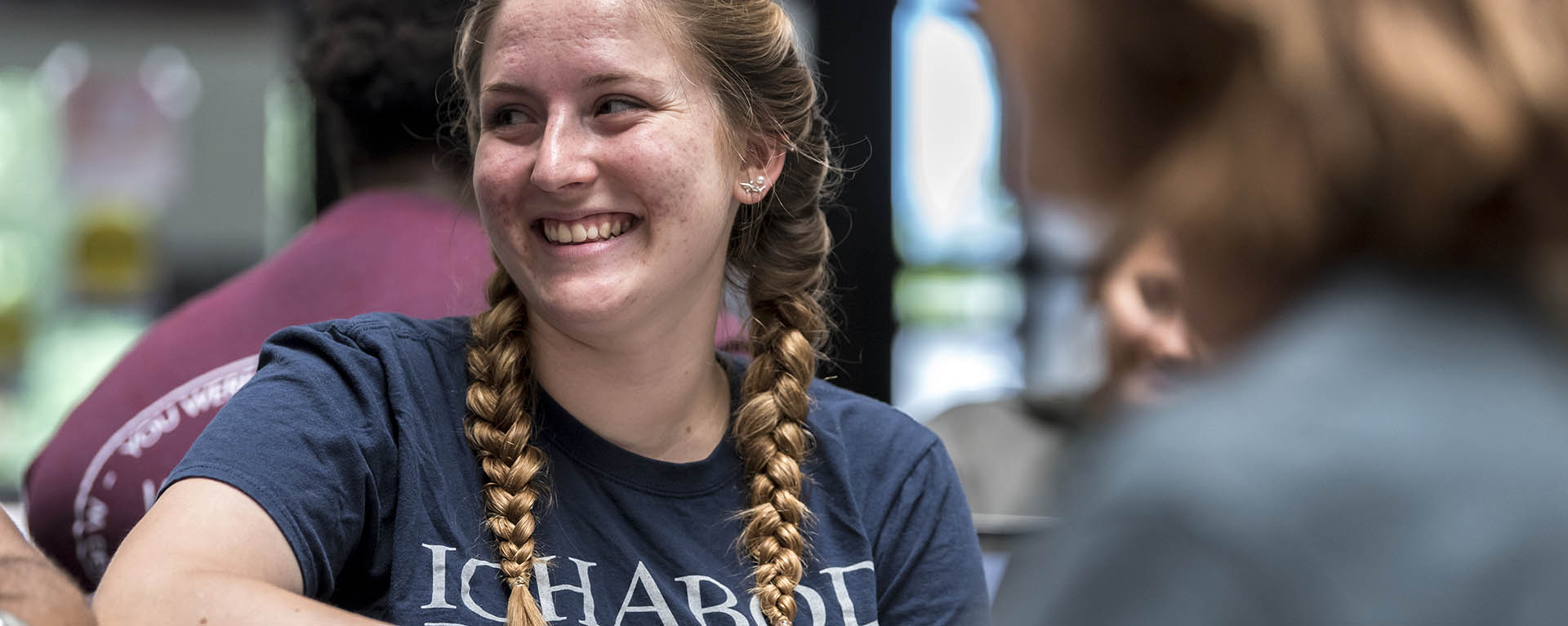 A student smiles while wearing a Washburn shirt
