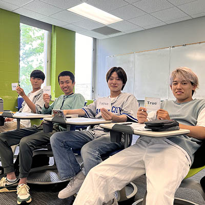 A group of international students smile and pose for a photo.