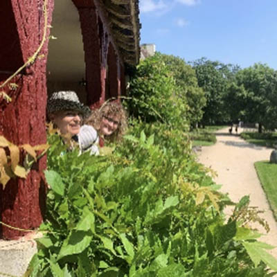 Petra leans out over a garden