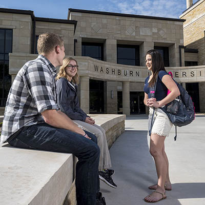 Students talk while hanging out in front of Morgan Hall.