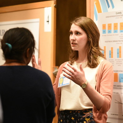 woman pinting to information while talking with a man