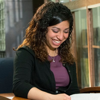 hispanic female laughing with book