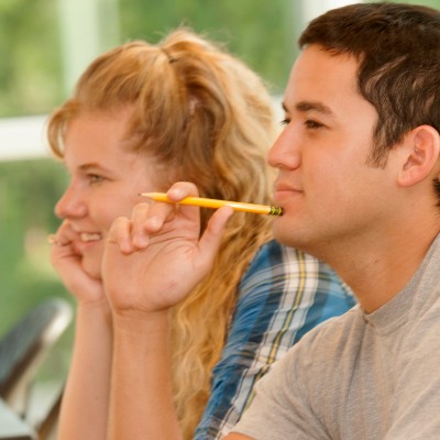 male student holding pencil