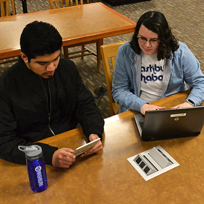 students looking at mobile device