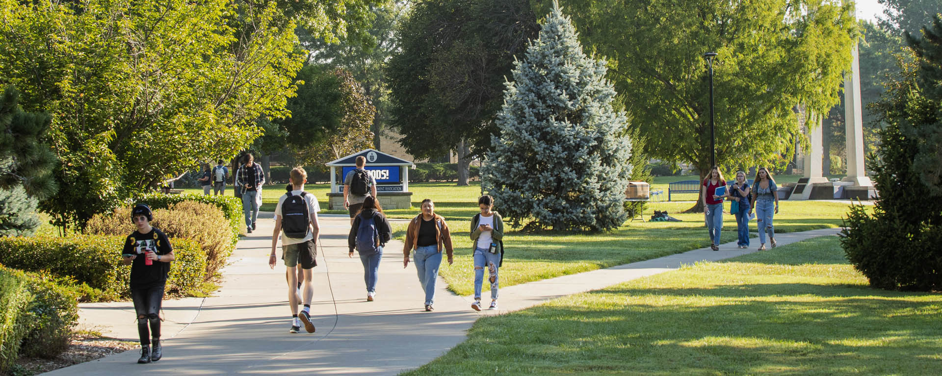 students walking on campus sidewalk