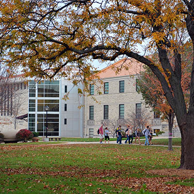 Memorial Union exterior with fall trees and students