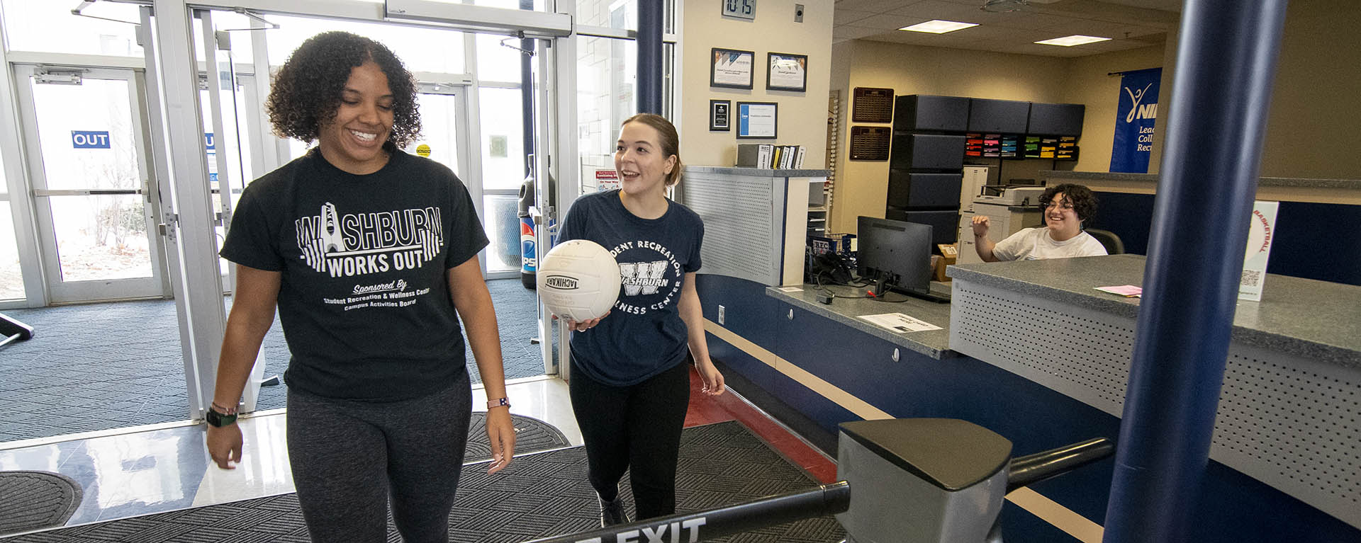 students laugh while walking into the Rec Center.