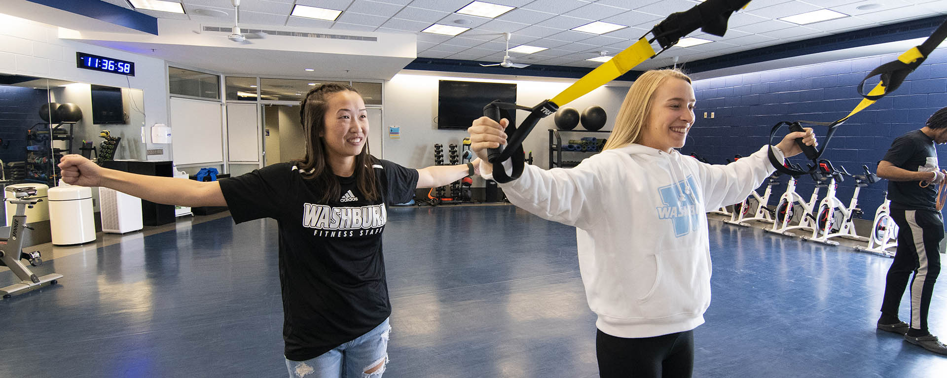 A personal trainer explains an exercise involving bands.