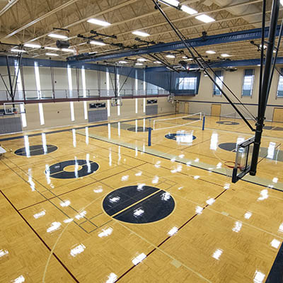 Empty gym composed of three basketball courts.