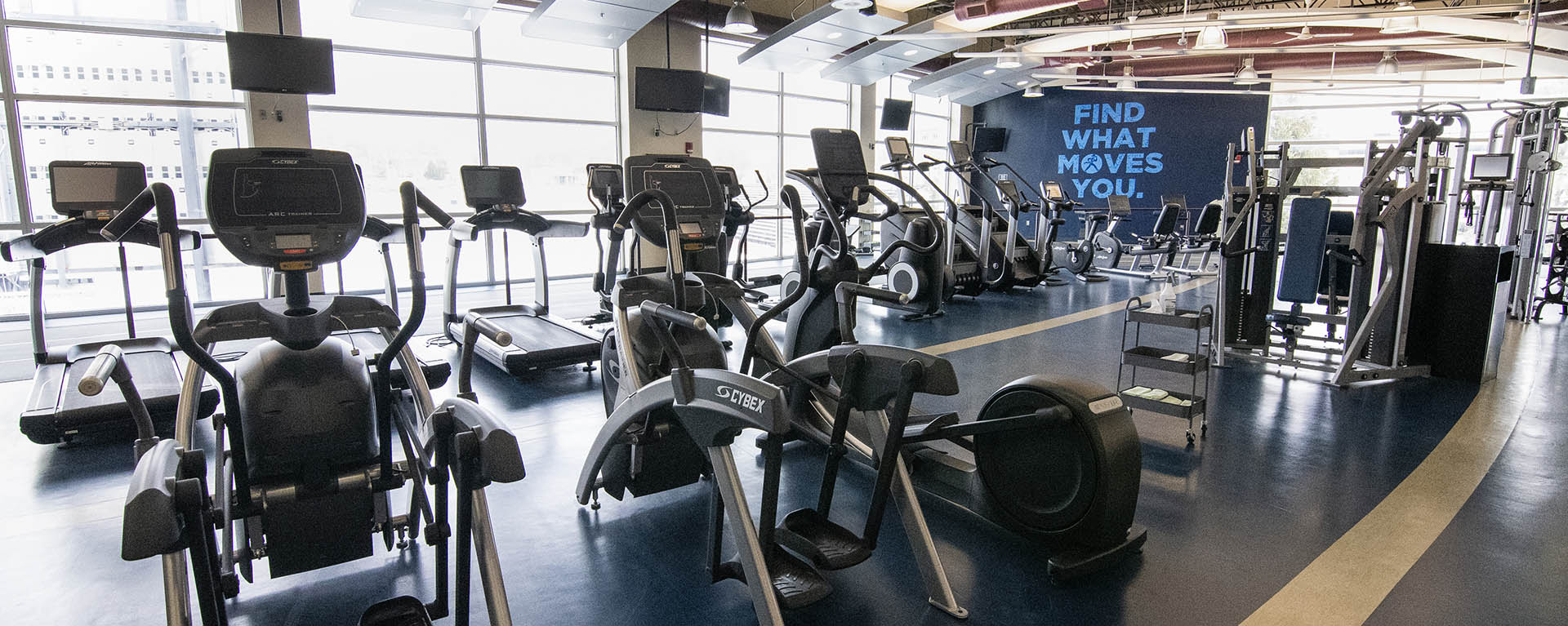 The fitness loft with treadmills and cardio machines overlooking the football stadium.