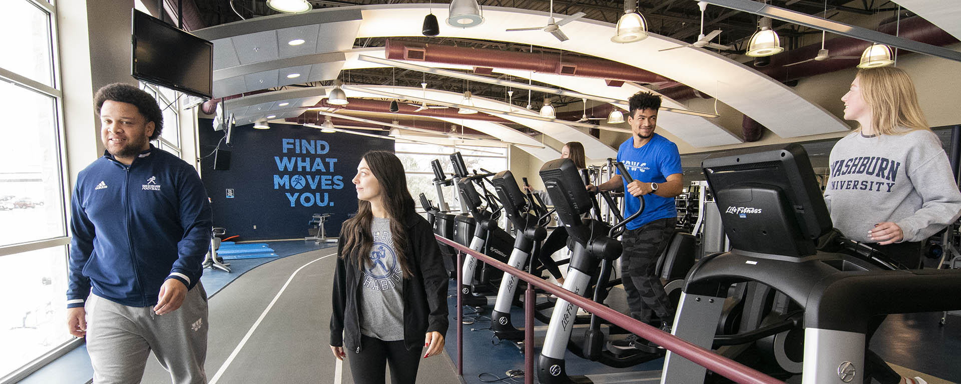 Students walk the track while others workout in the fitness loft at the SRWC.