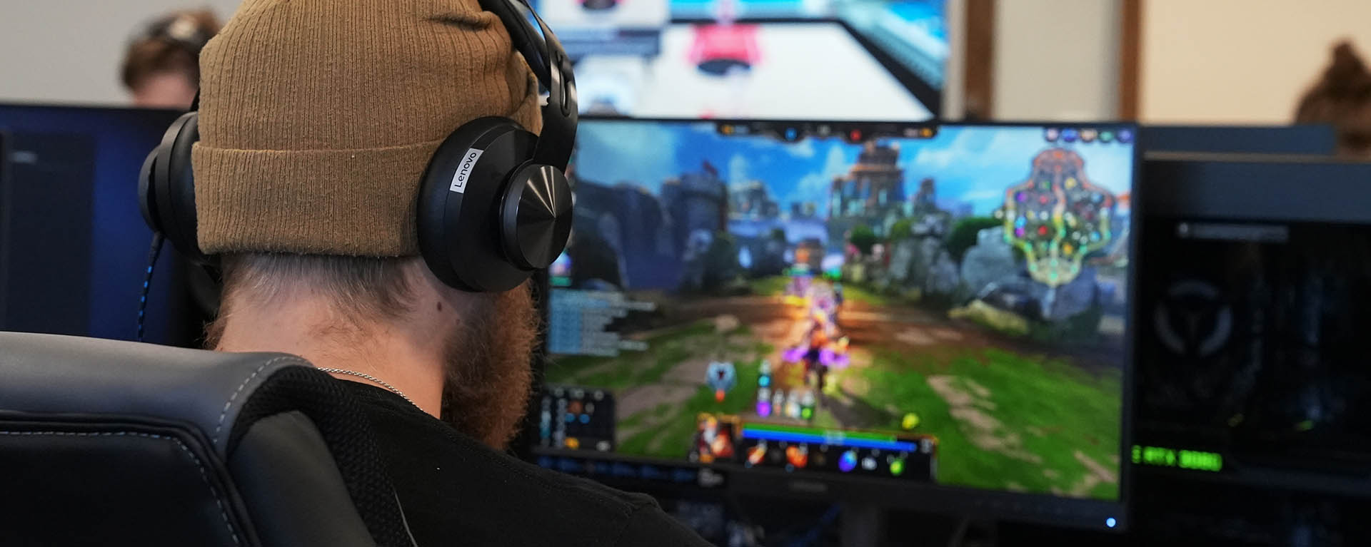 A student plays a game on a computer screen in the esports lounge.