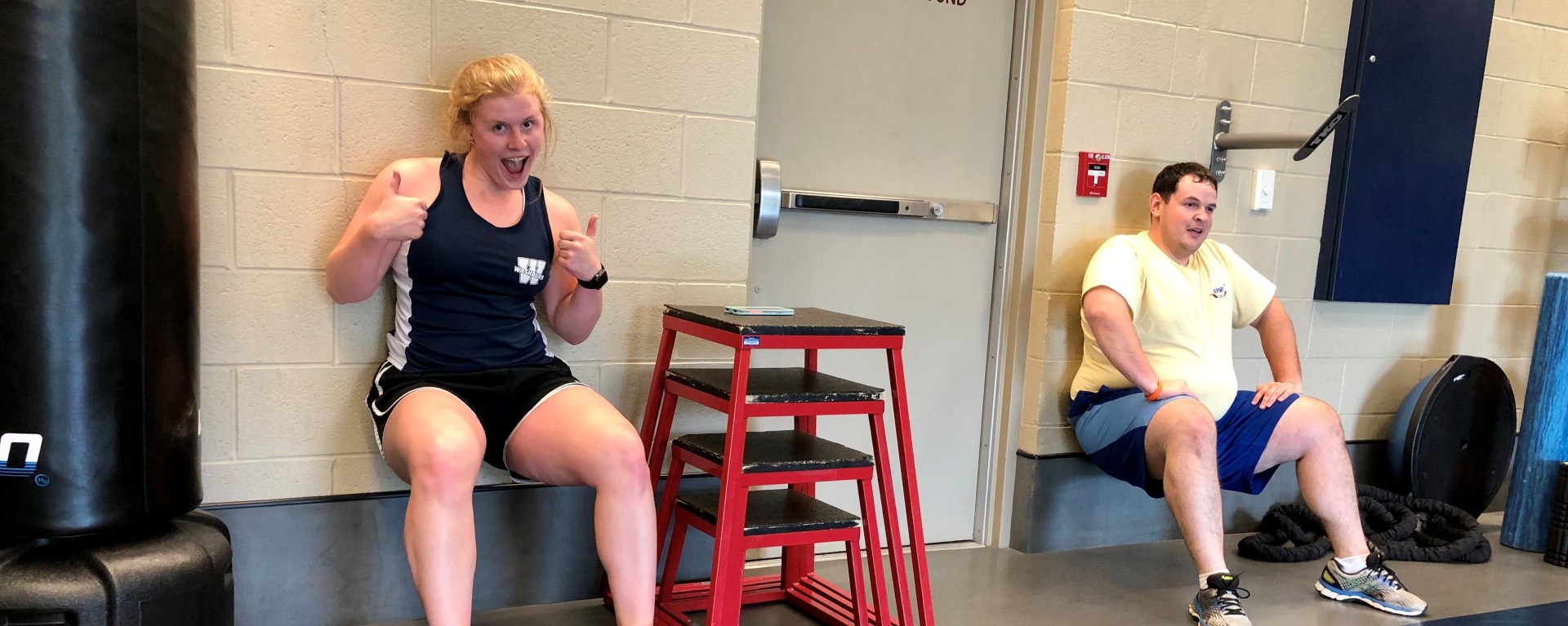 2 people doing wall sits