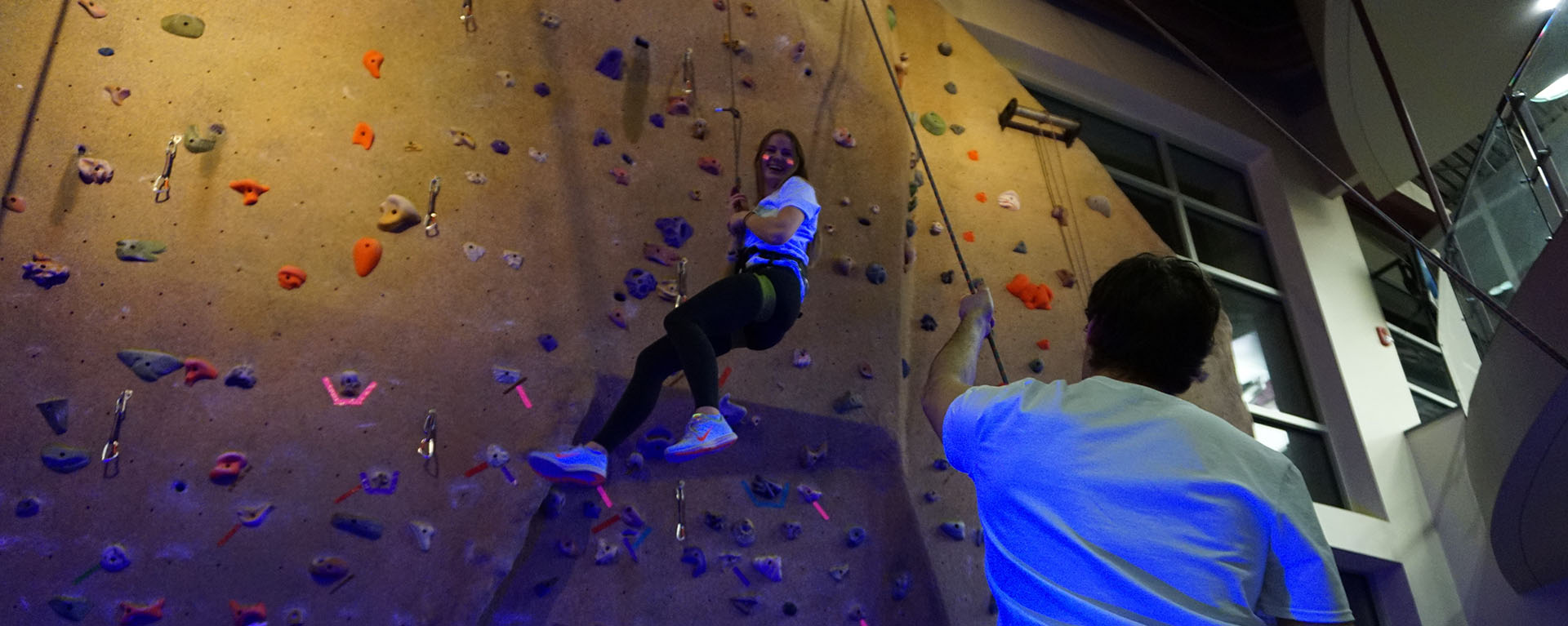 woman climbing wall