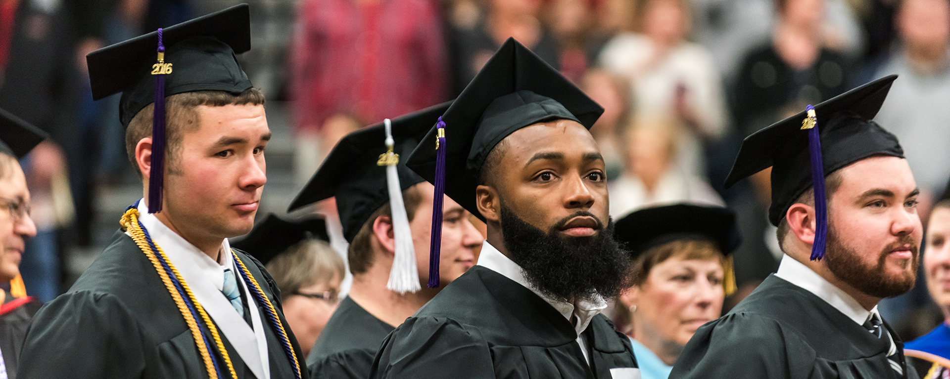 Washburn students become alumni as the walk during commencement.