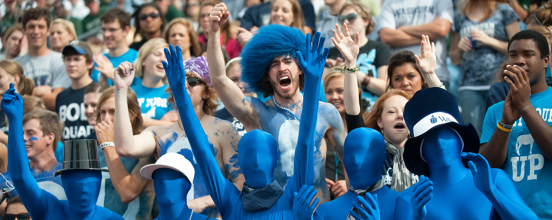 Students cheering at football game